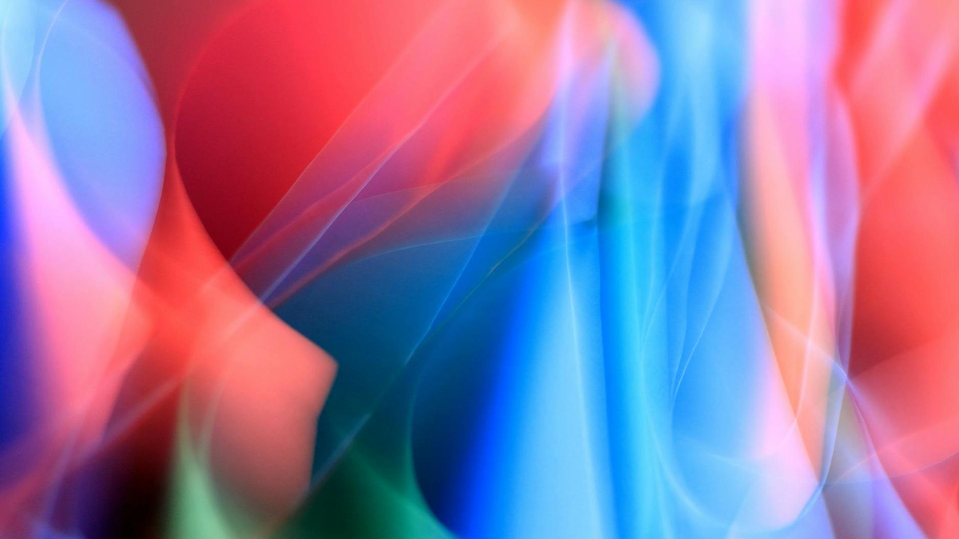 Abstract soft light trails creating a sense of fluid motion.